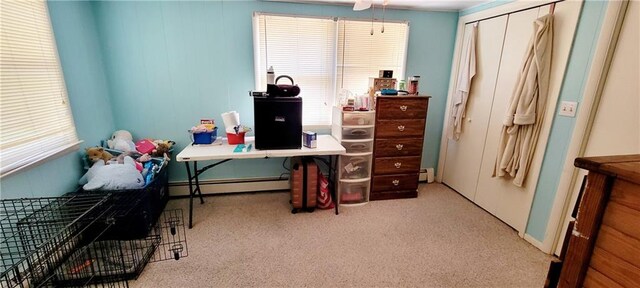 carpeted office with a baseboard radiator