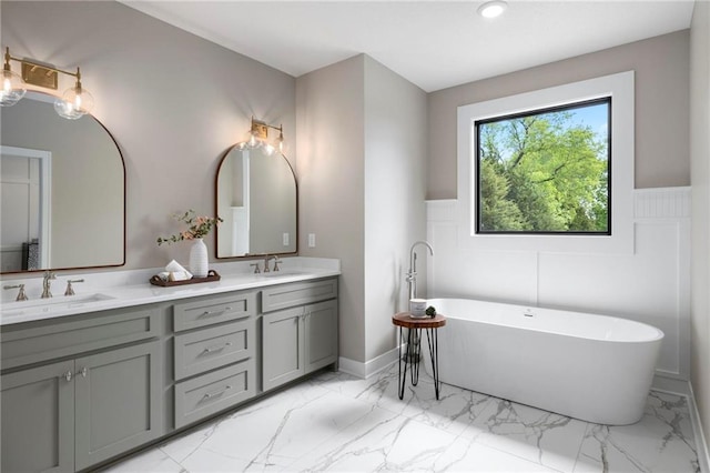 bathroom featuring a tub to relax in and vanity