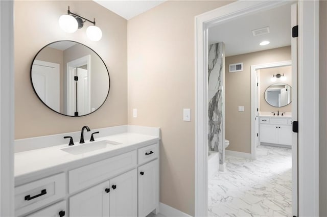 bathroom featuring vanity and toilet