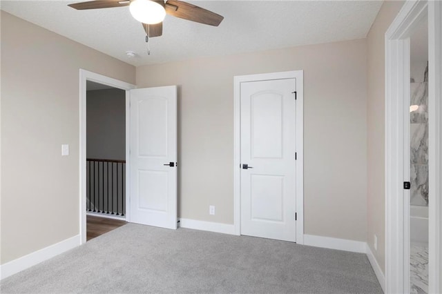 unfurnished bedroom featuring carpet flooring and ceiling fan