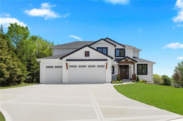 view of front facade with a garage and a front yard