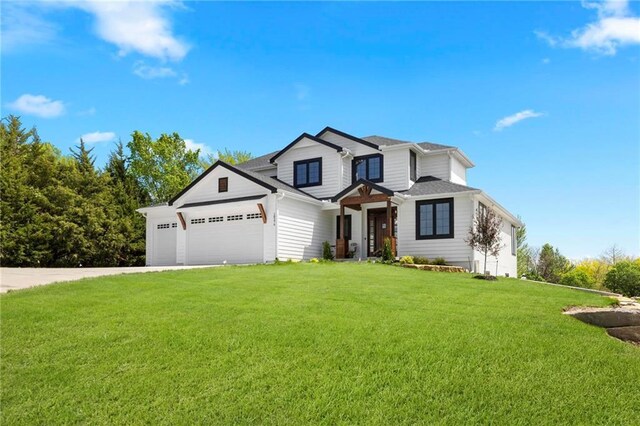 view of front of house with a garage and a front yard