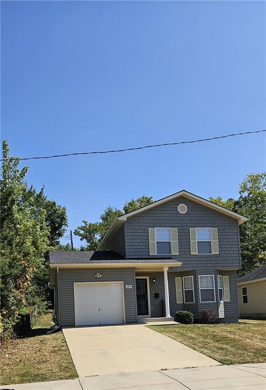 view of front facade with a front lawn and a garage