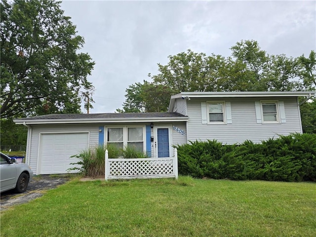 tri-level home with a front yard and a garage