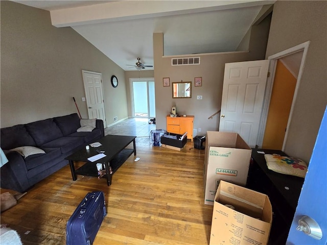 living room with ceiling fan, hardwood / wood-style floors, and lofted ceiling with beams