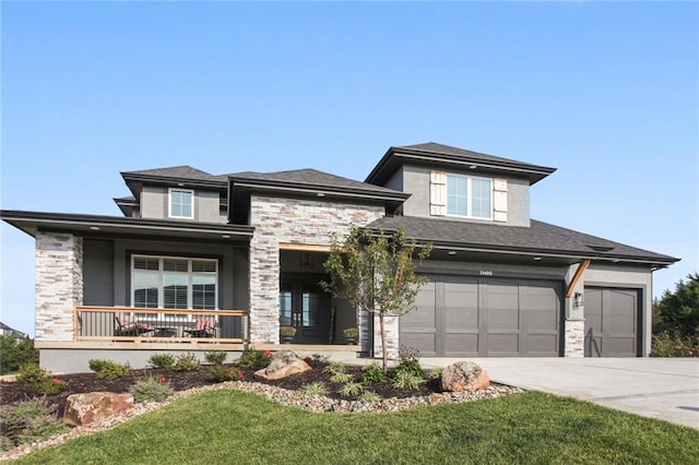 prairie-style home with a front lawn, a garage, and covered porch