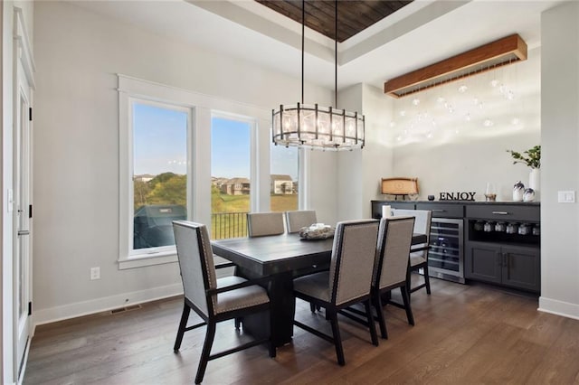 dining area featuring wood ceiling, dark wood-type flooring, wine cooler, and a notable chandelier