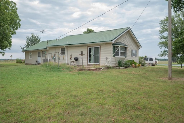 back of property featuring a yard