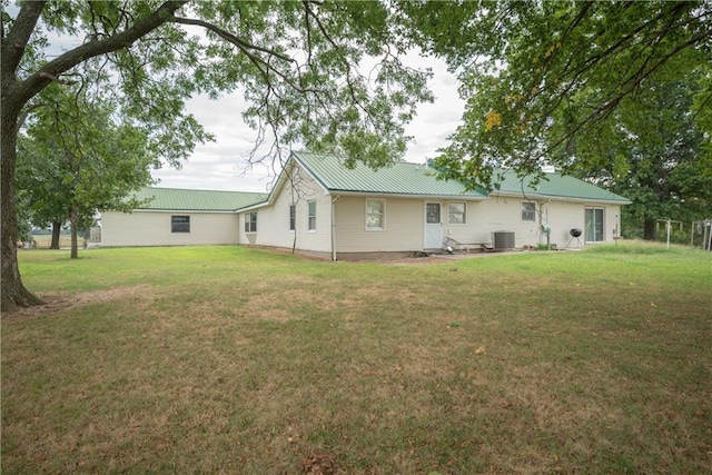 back of house with a yard and central AC unit