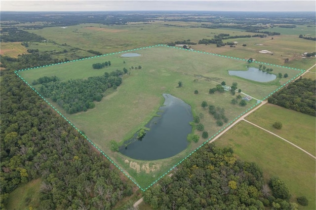 birds eye view of property featuring a water view and a rural view