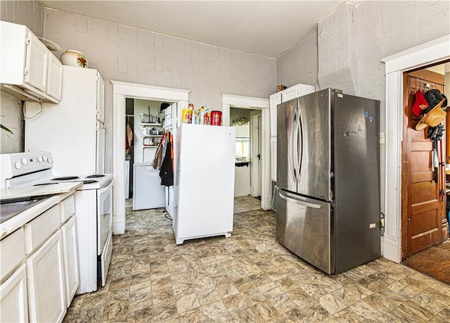 kitchen featuring white appliances and white cabinets