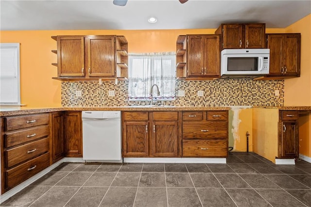 kitchen featuring white appliances, ceiling fan, decorative backsplash, and sink