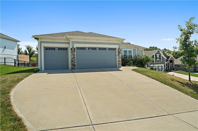 view of front of property with a front yard and a garage