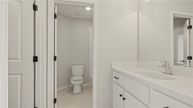 bathroom featuring vanity, a bath, tile patterned flooring, and toilet