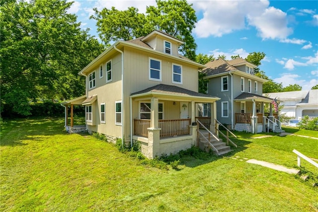 rear view of house with a lawn and a porch