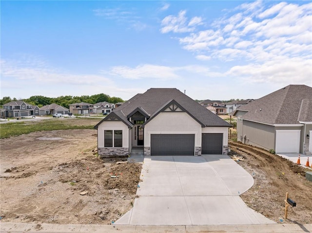 view of front of house featuring stucco siding, a garage, a residential view, stone siding, and driveway