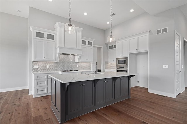 kitchen featuring visible vents, white cabinets, appliances with stainless steel finishes, dark wood-type flooring, and a sink