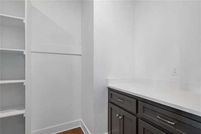 bathroom with baseboards and wood finished floors