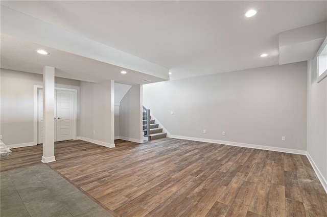 finished basement featuring baseboards, stairway, wood finished floors, and recessed lighting