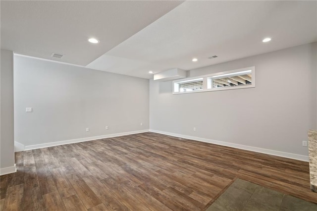 basement with baseboards and wood finished floors