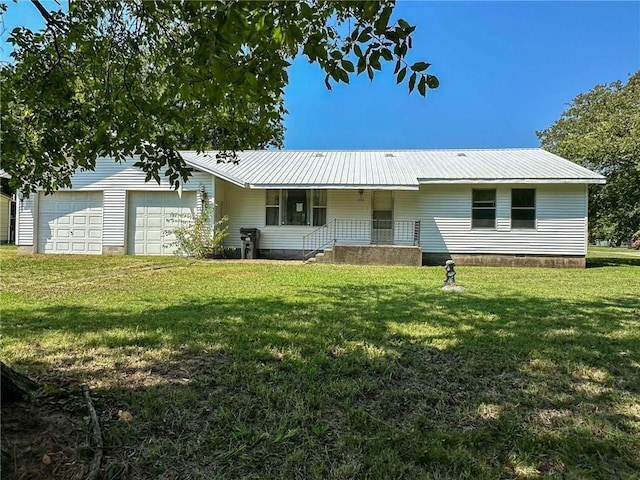 ranch-style home featuring metal roof, crawl space, a front yard, and driveway