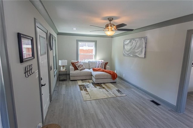 living area with hardwood / wood-style flooring and ceiling fan