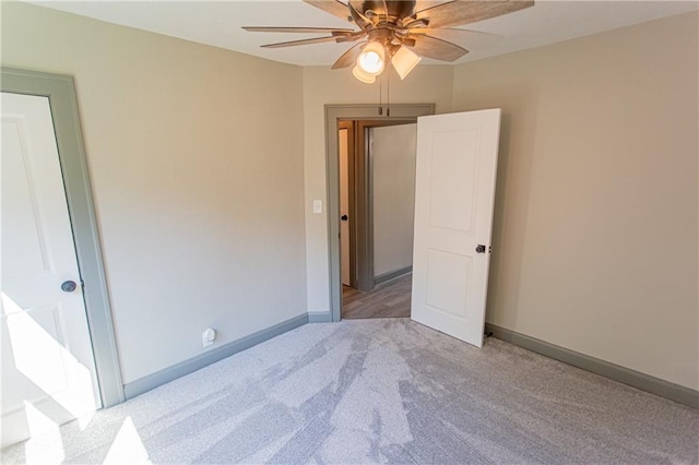 interior space featuring light carpet and ceiling fan