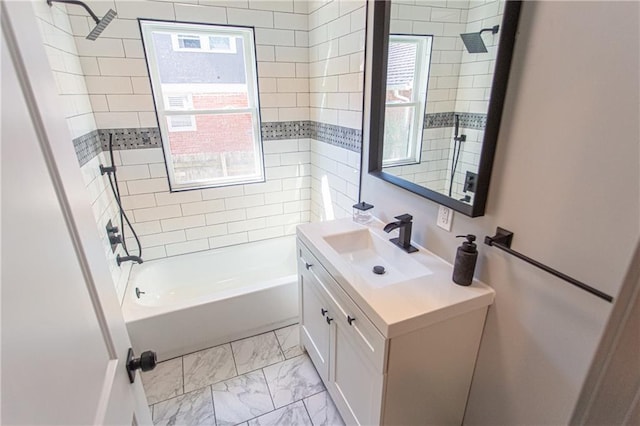 bathroom with tiled shower / bath and vanity