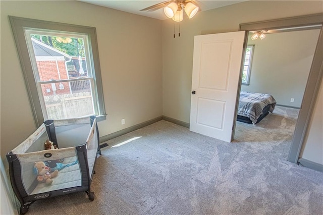 bedroom with light colored carpet and ceiling fan