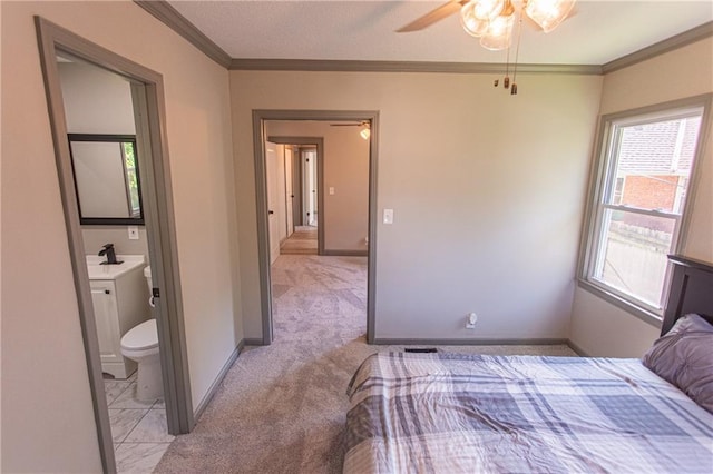 unfurnished bedroom featuring light carpet, crown molding, ensuite bath, and ceiling fan