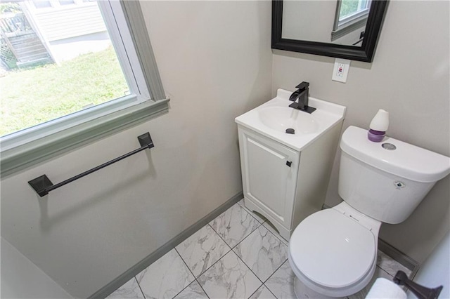 bathroom with a healthy amount of sunlight, toilet, and vanity