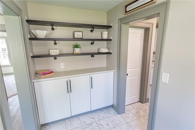 bar featuring white cabinetry