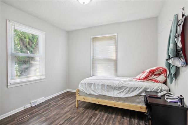 bedroom featuring dark hardwood / wood-style flooring