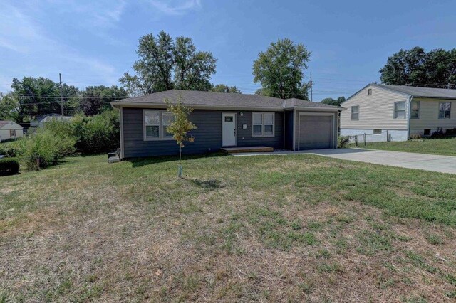 view of front of property with a front lawn and a garage