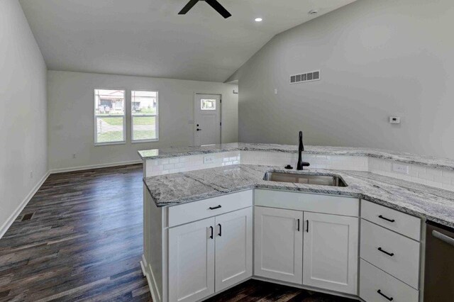 kitchen featuring lofted ceiling, white cabinetry, sink, and dark hardwood / wood-style flooring