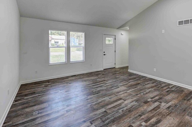 entrance foyer with dark hardwood / wood-style flooring and lofted ceiling