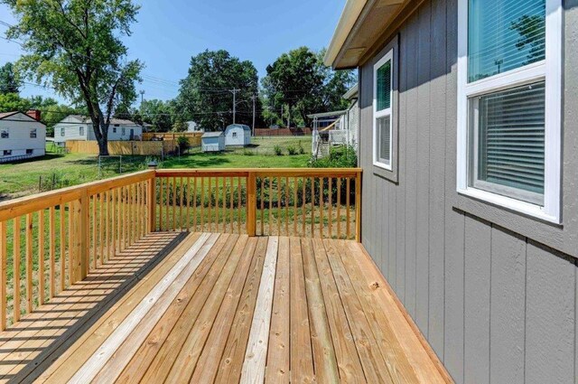 deck with a yard and a shed