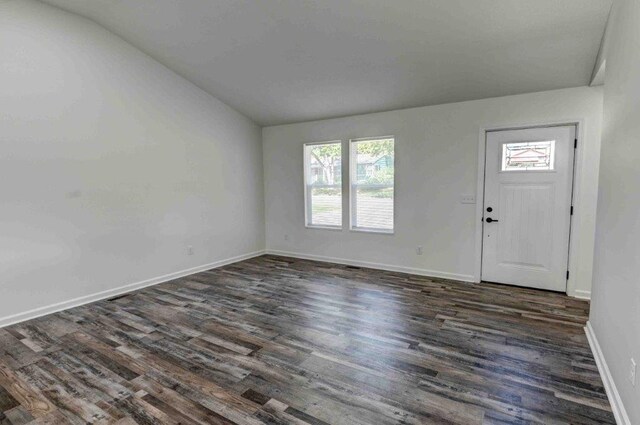 entryway featuring dark hardwood / wood-style floors and vaulted ceiling