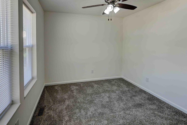 unfurnished room with ceiling fan and carpet