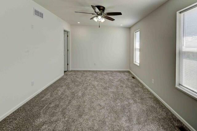 carpeted empty room with ceiling fan