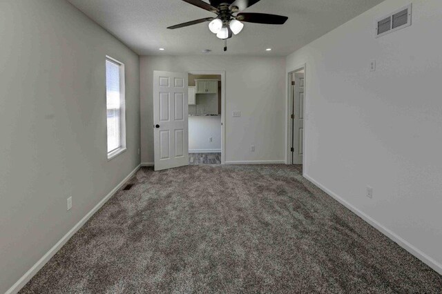 unfurnished bedroom with ceiling fan and carpet floors