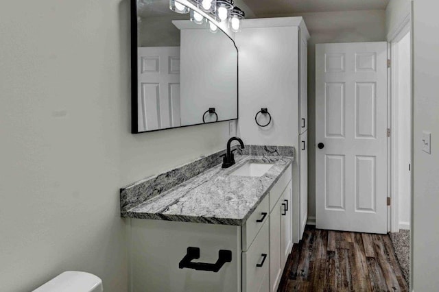 bathroom featuring vanity, toilet, and wood-type flooring