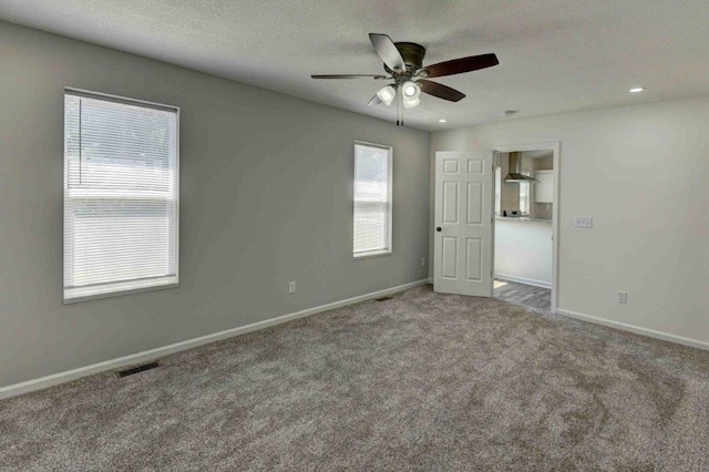 unfurnished room featuring carpet and ceiling fan