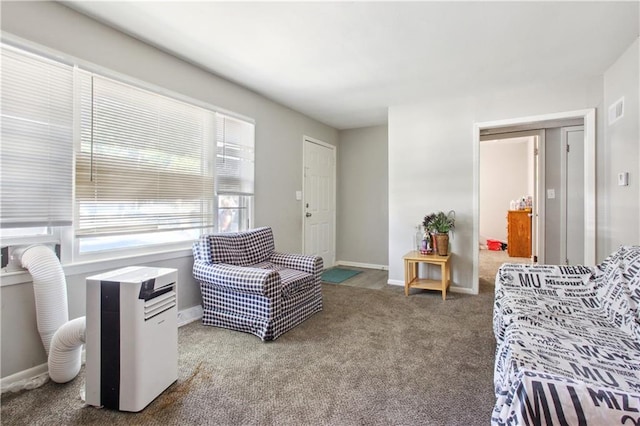 sitting room featuring carpet floors, visible vents, and baseboards