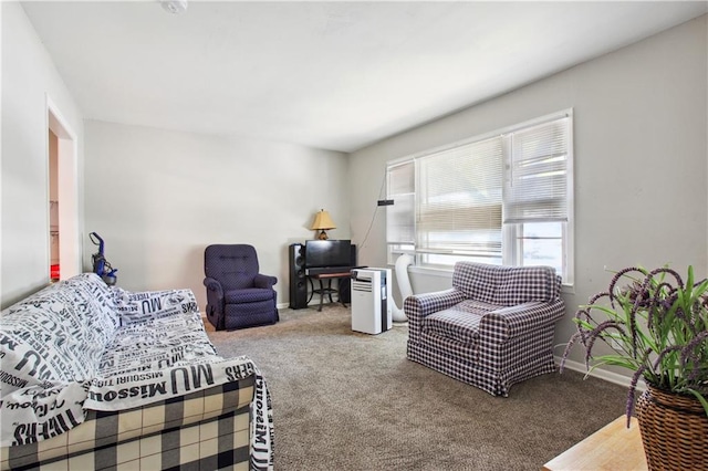 carpeted living room featuring baseboards