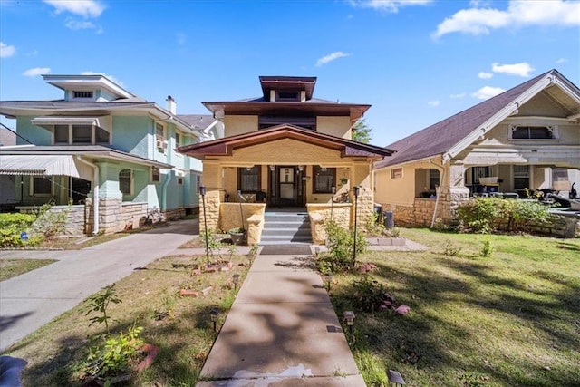 view of front of property featuring a front yard and a porch