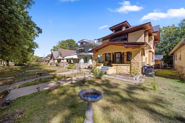 view of front facade with a patio and a front lawn