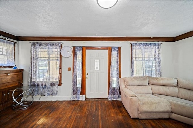 entryway with a textured ceiling and dark hardwood / wood-style flooring