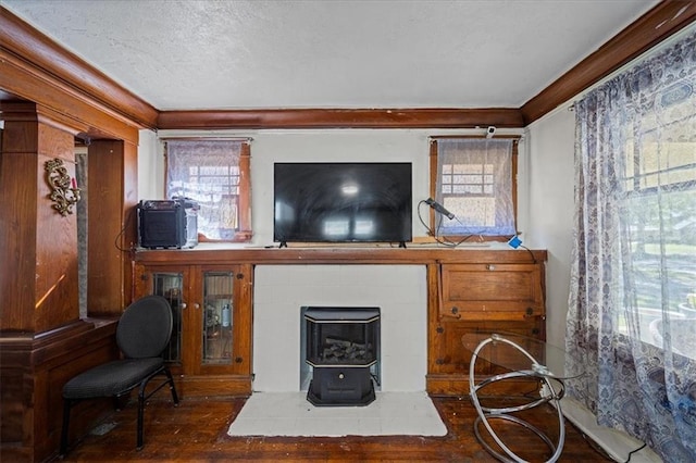 3917 Benton Blvd, Kansas City, MO 64130 - living area featuring ornamental molding, a wood stove, wood-type flooring, plenty of natural light, and a textured ceiling