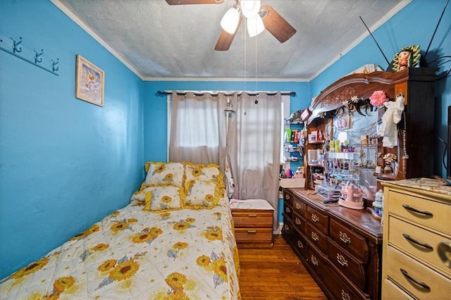 bedroom featuring a textured ceiling, ceiling fan, dark wood-type flooring, and crown molding